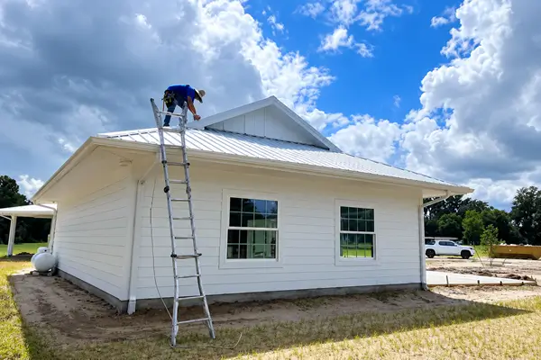 Lightning protection expert installing lightning rods on rooftop